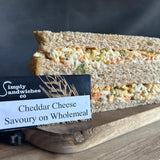 A triangular simply sandwiches made with wholemeal bread and creamy cheddar cheese filling perfect for snacks