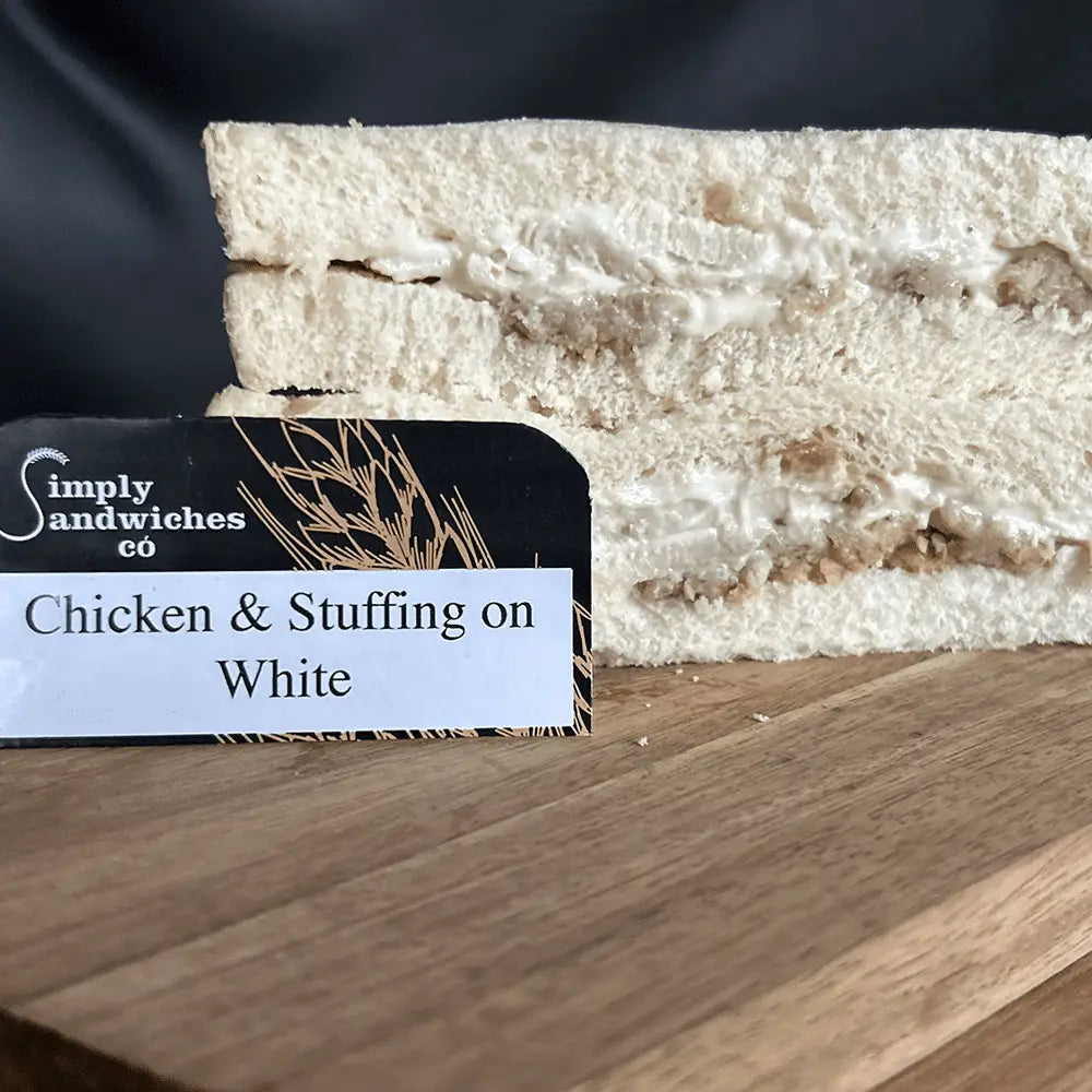 A simply sandwiches layered chicken and stuffing sandwich on white bread with creamy filling and herbs perfect for bon sweets pouches