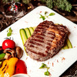 Grilled sirloin steak with distinct sear marks on white plate made from high-quality meat perfect for free range chinese meals