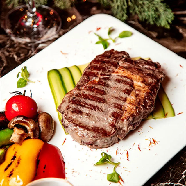 Grilled sirloin steak with distinct sear marks on white plate made from high-quality meat perfect for free range chinese meals