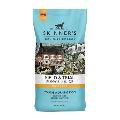 A light blue bag of skinners field & trial puppy duck & rice dog food with a rustic stone house and garden illustration