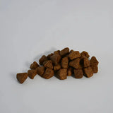 Brown irregular kibble pieces from skinners field field and trial puppy duck and rice dog food