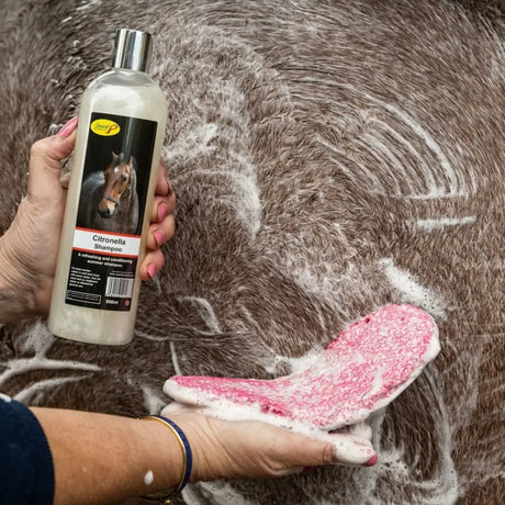 A clear plastic bottle with silver cap labeled tennor p containing white liquid smart grooming citronella shampoo