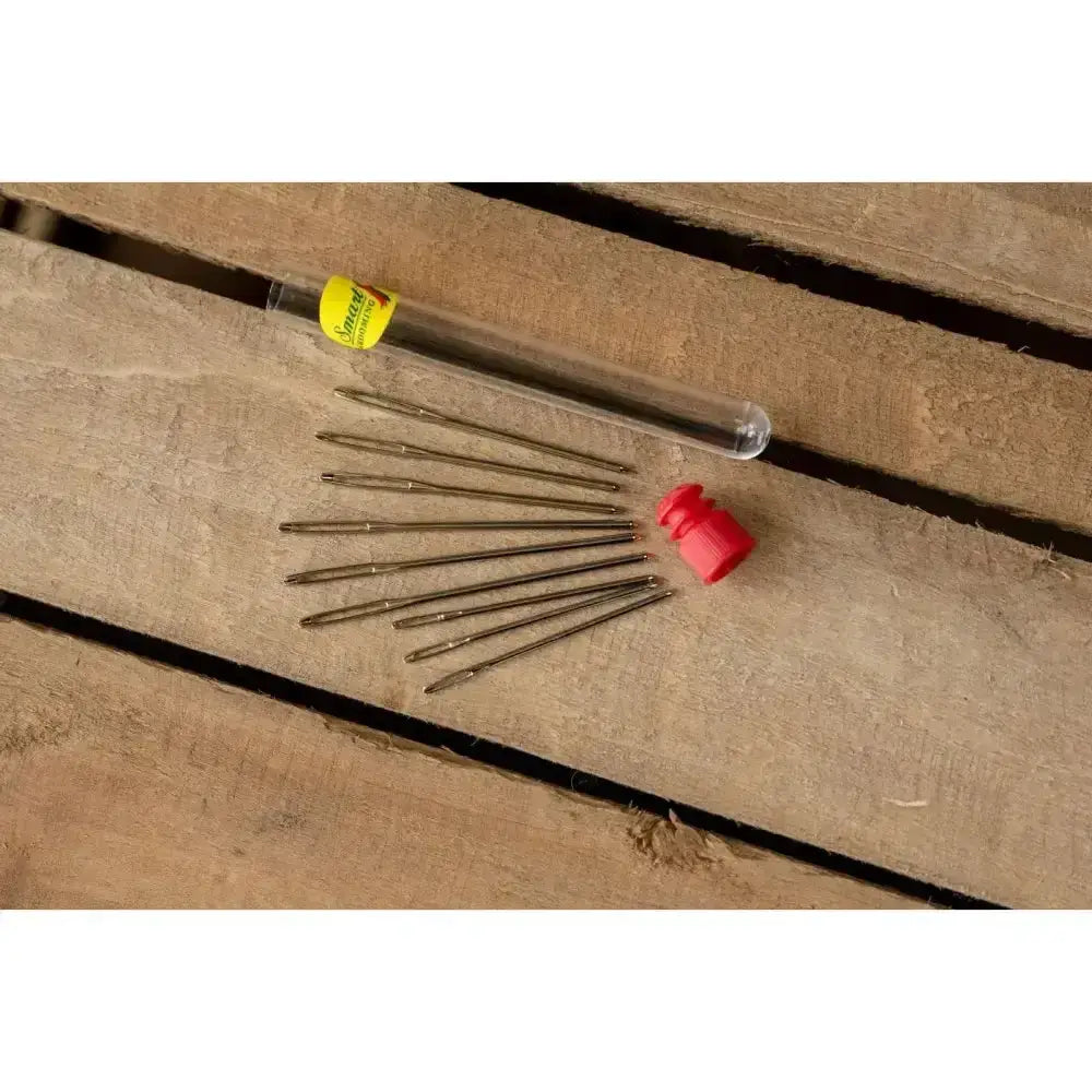 Set of ten brass-colored metal smart grooming plaiting needles with yellow-labeled tube and red cap for braiding horses