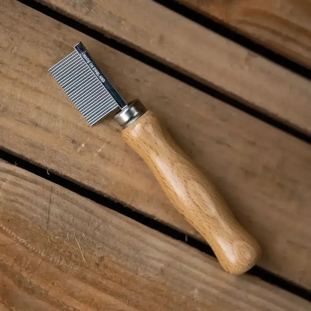 Wooden-handled smart grooming quarter marking comb with metallic finely toothed head engraved made in england
