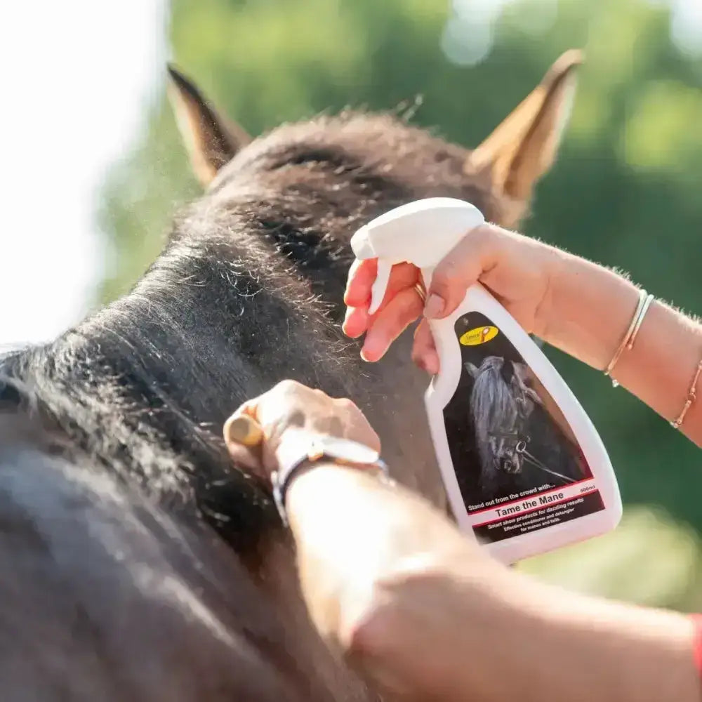 White spray bottle of smart grooming tame the mane 500ml with black yellow label for horse mane care in challenging conditions