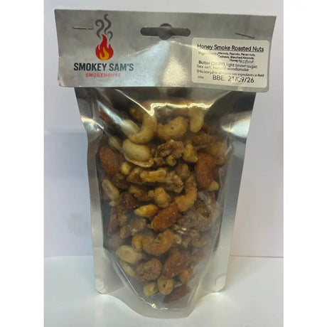 A shiny silver pouch of smokey sams honey roast hickory smoked nuts with cashews almonds and peanuts coated in brown sugar