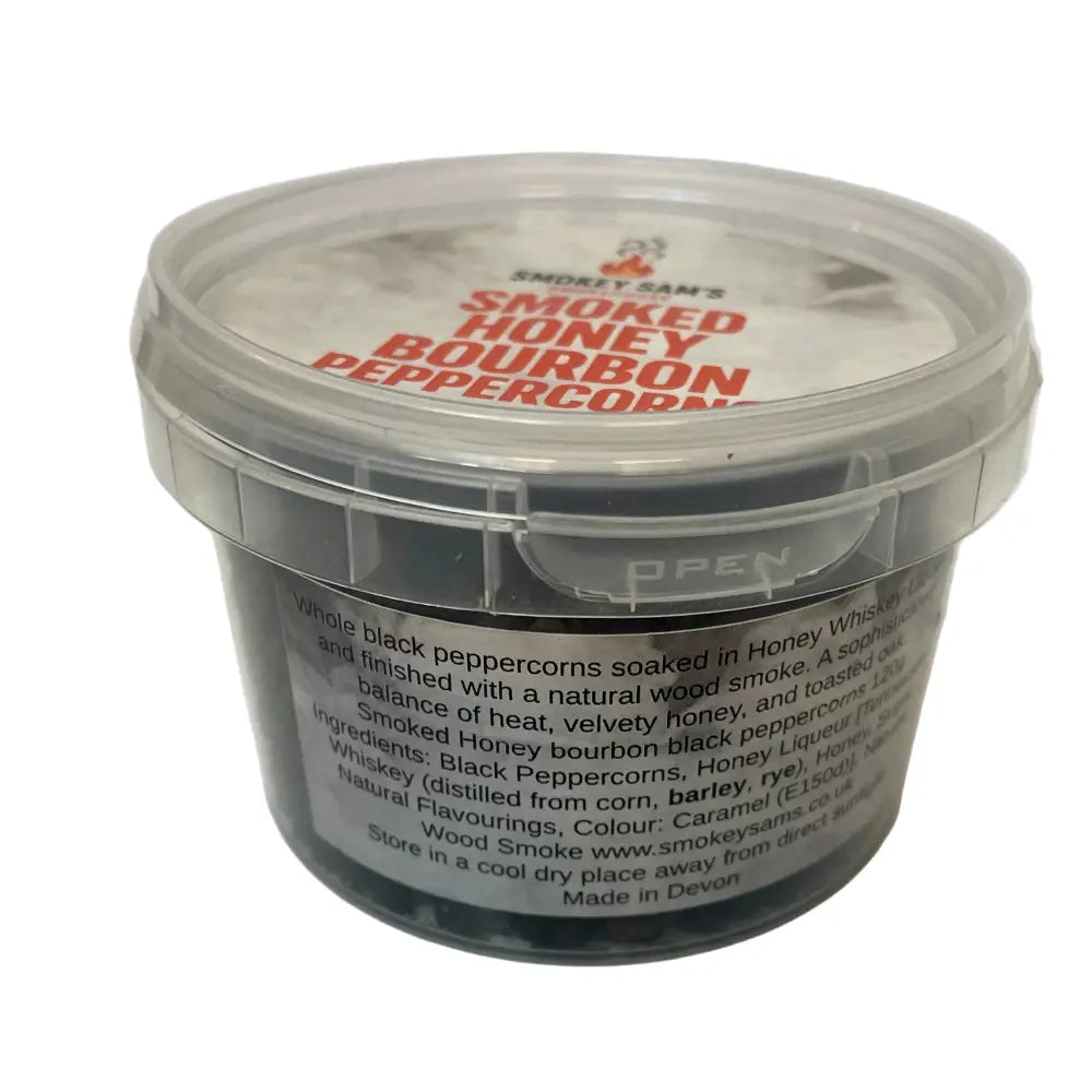 Smokey sams smoked honey bourbon peppercorns in a clear plastic container with matching lid for easy use