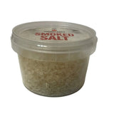Clear plastic container of smokey sams smoked salt with red label and transparent lid featuring premium sea salt