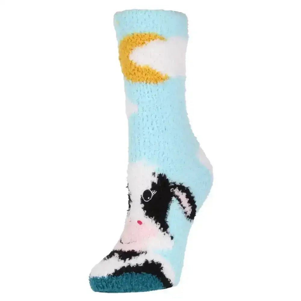 Light blue fuzzy sockshop wild feet cosy adults socks with black and white cow design and yellow crescent moon cuff