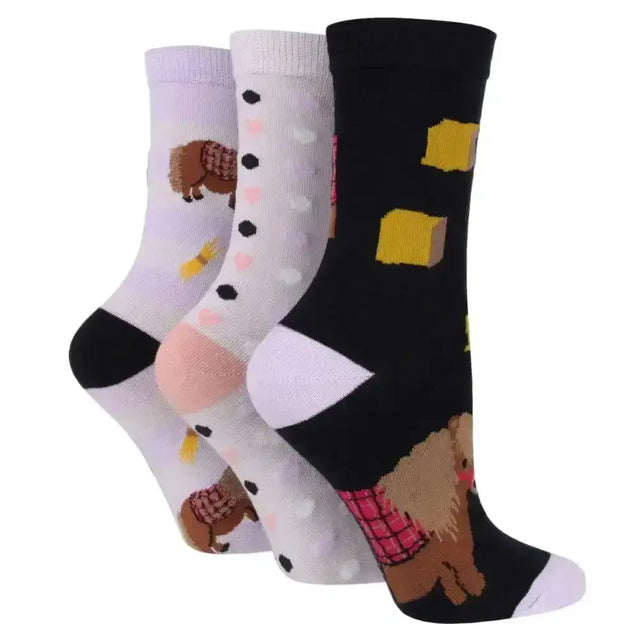 Three sockshop wild feet cotton crew socks with fun animal-themed dog designs in pastel and black cotton blend