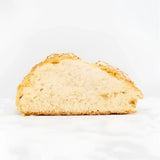 A golden brown crusty round white bread loaf with airy interior and seeds, perfect soda bread option