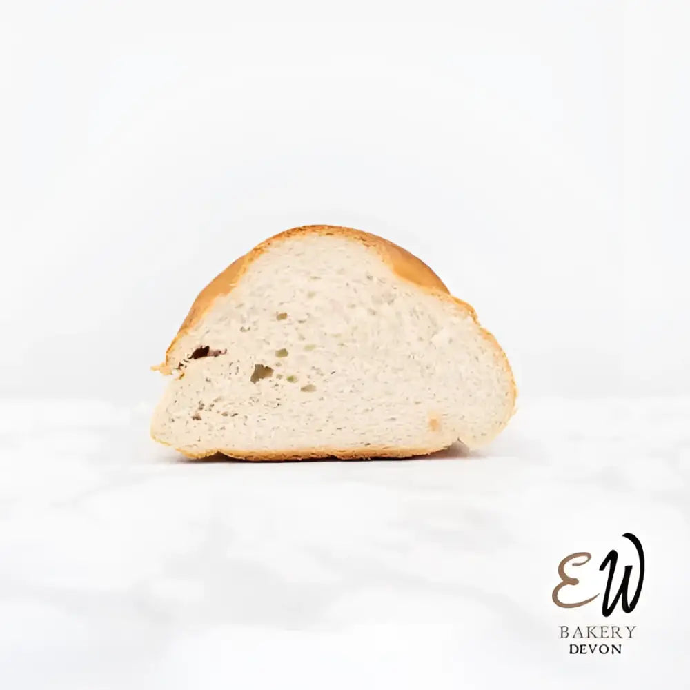 A golden-brown soft sourdough white bread loaf with a crusty exterior and airy round white interior