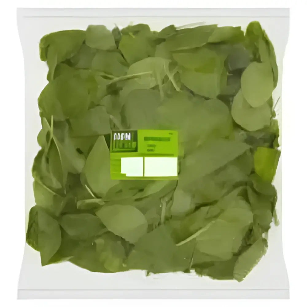 A clear plastic container of fresh green spinach leaves with a bright lime green label ideal for healthy equestrian meals