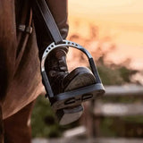 Black sprenger flexicite grip stirrup with metallic silver ring and textured footbed for better grip