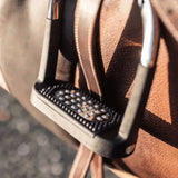 Black studded sprenger flexicite grip stirrup with metallic silver accents and durable textured design