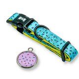 Turquoise and yellow donut patterned days collar with black buckle and matching pink sprinkle charm collar pink