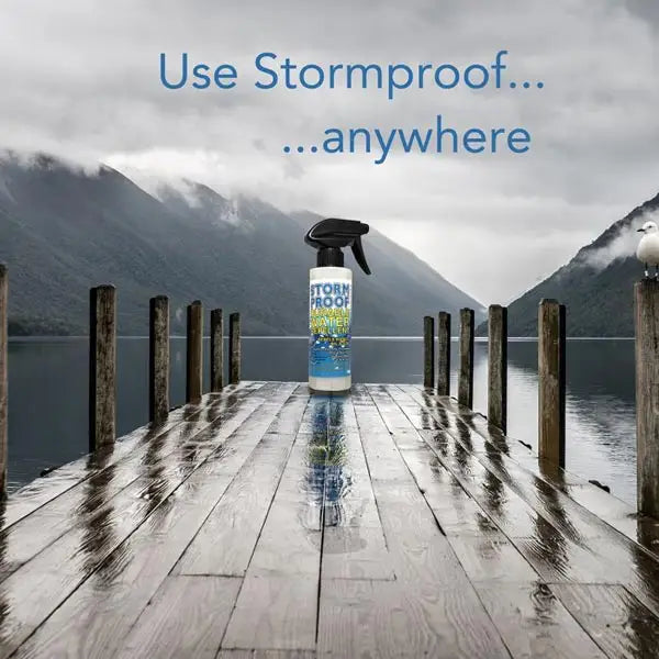 A white stormproof water repellent spray 500ml bottle with black nozzle and blue label, no nauseating chemical smell