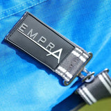 Metal badge with EMPRA on blue fabric of StormX Empra 0g Turnout Rug