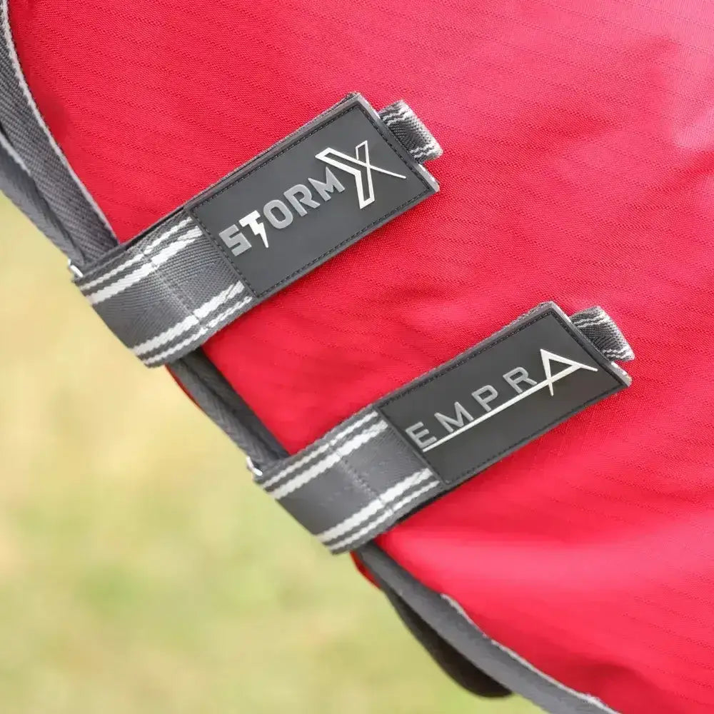 Red stormx and empra branded gray webbing straps with black leather labels on a combi turnout rug back side