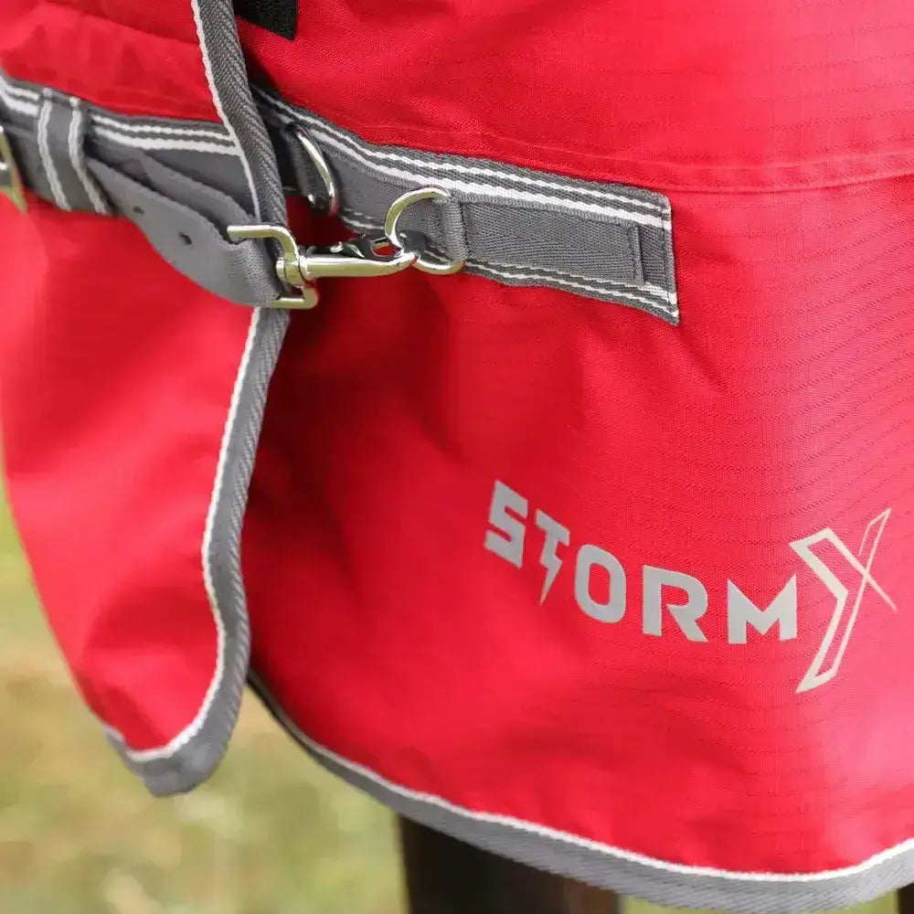 Red stormx combi turnout rug with gray trim and metal buckle from the stormx empra 300 combi turnout line