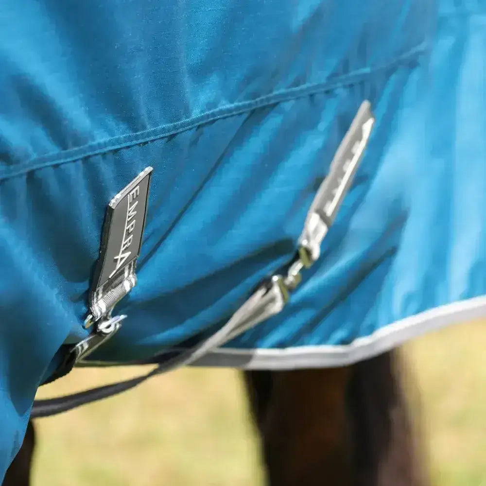 Blue stormx empra 50 combi turnout rug with silver zippers and a black brand tag perfect for all weather use