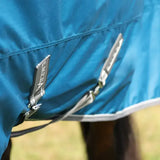 Blue stormx empra 50 combi turnout rug with silver zippers and a black brand tag perfect for all weather use