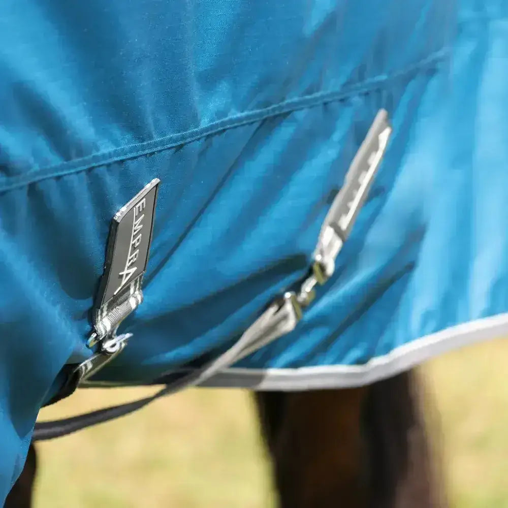 Blue stormx empra 50 turnout rug with silver zippers and black brand tag perfect for equestrian use