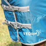 Blue stormx empra turnout rug with gray straps and silver buckles for equestrian use