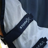 Black embroidered stormx label on white mesh fabric of stormx empra aqua shield fly rug