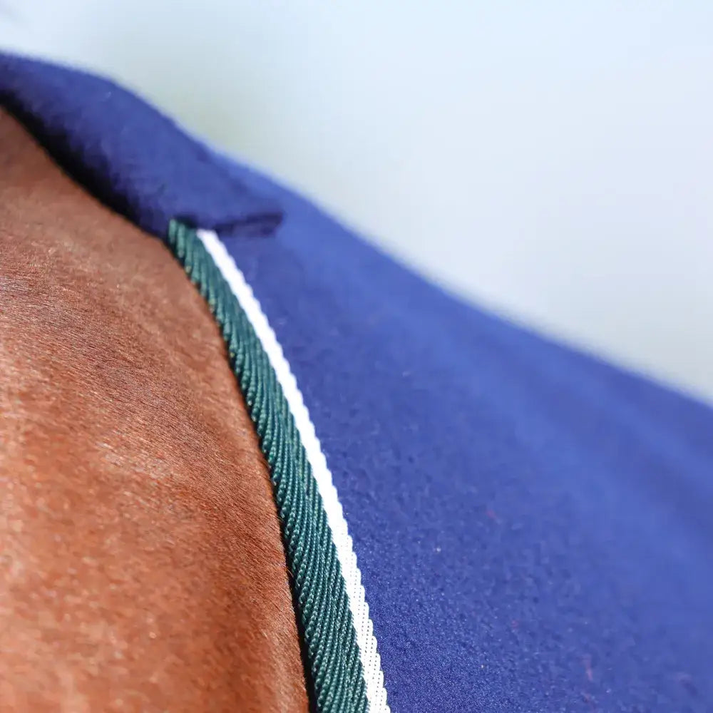 Close-up of shoulder in blue garment with green and white trim of StormX Empra Opulence