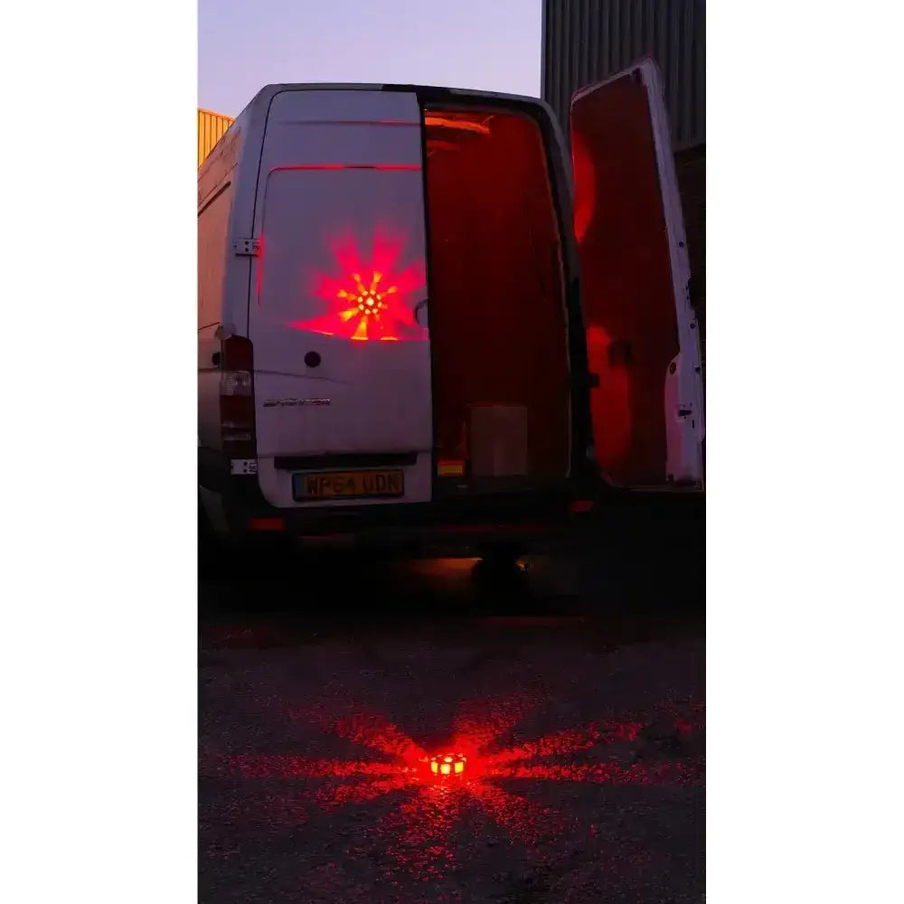 Red led light array on ground projecting onto white van rear door from streetflare horse box hazard warning kit