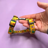 Yellow floral-patterned summer buzzin teacup puppy strap harness with black plastic buckles for small pups