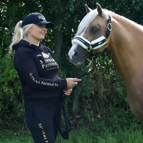 Black and white horse halter with plush trim shown alongside supreme products active rider joggers for comfort