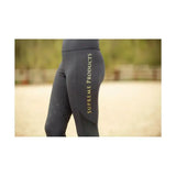 Black supreme products active rider leggings with flattering fit and gold vertical branding on the outer thigh