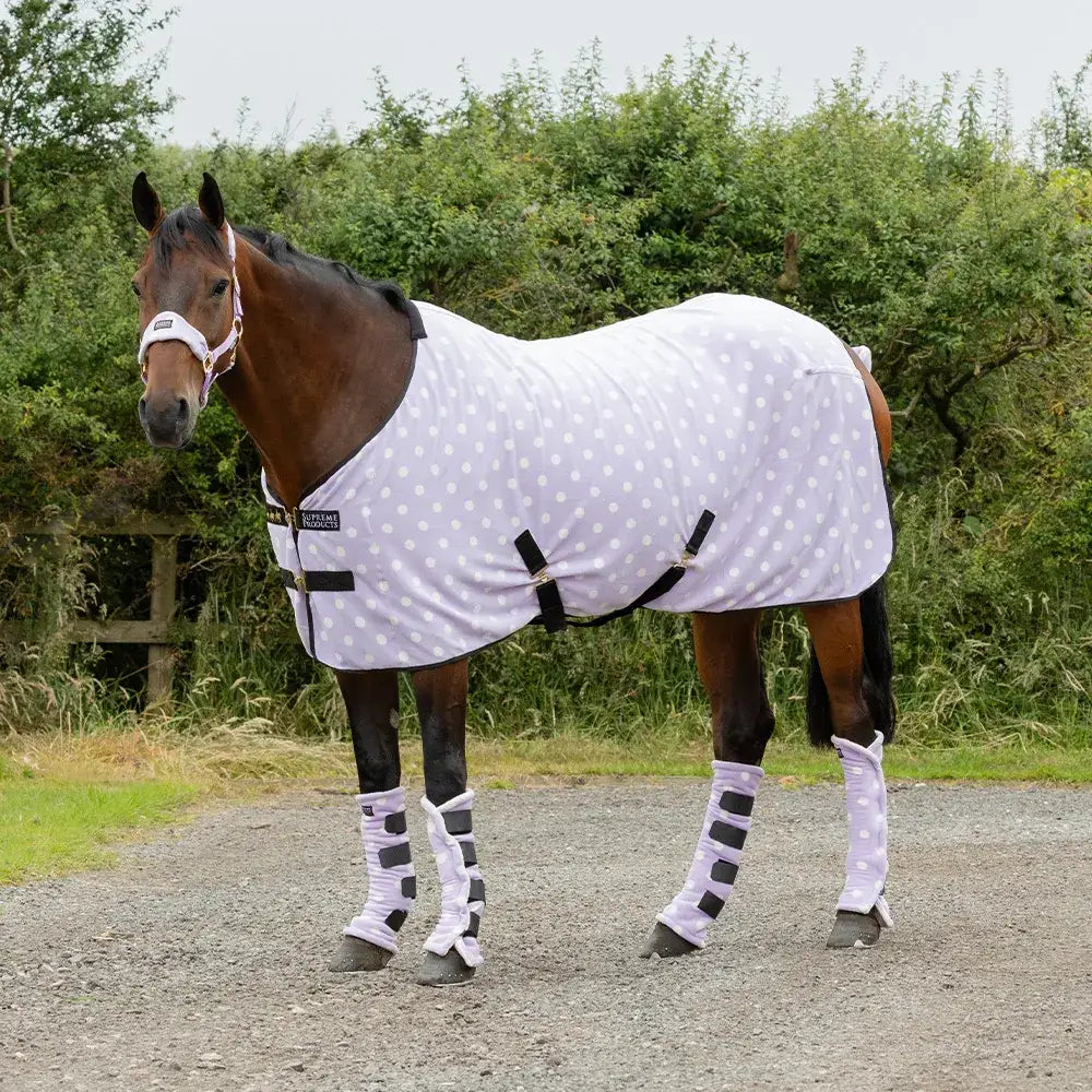 White polka-dot supreme products dotty fleece rug with black straps and matching leg wraps for versatile soft fleece warmth