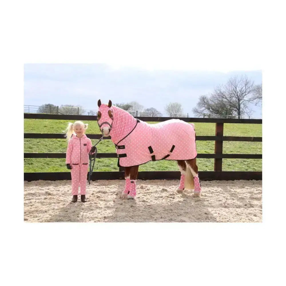 Pink polka-dot supreme products dotty fleece rug with black straps and matching leg wraps for soft versatile use