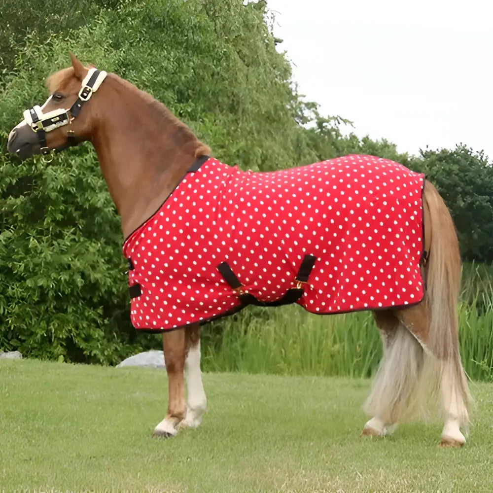 Red polka dot supreme products dotty fleece rug with black straps and white trim made of versatile soft fleece