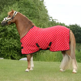 Red polka dot supreme products dotty fleece rug with black straps and white trim made of versatile soft fleece