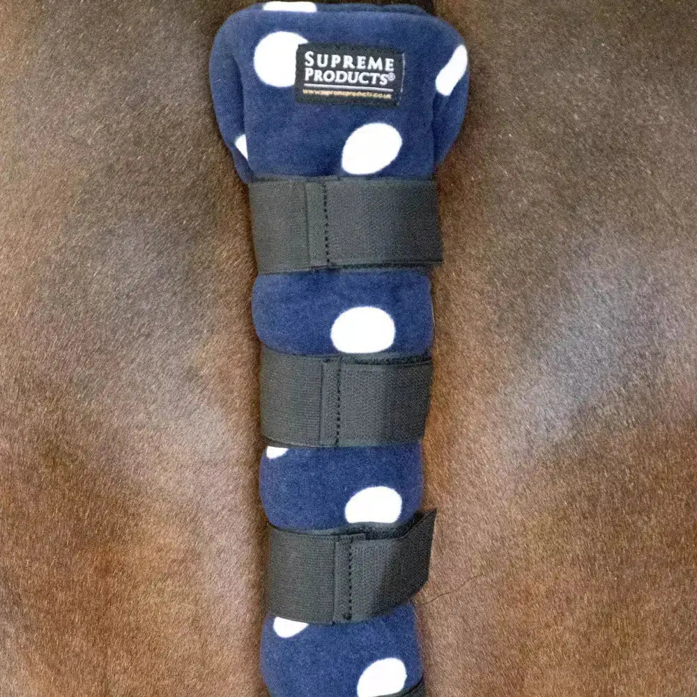 Navy blue fleece tail guard with white polka dots and black straps from supreme products dotty collection