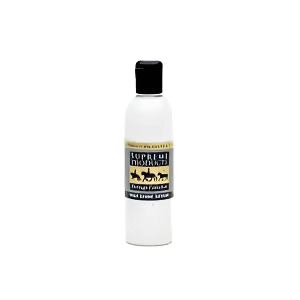 A clear plastic bottle with a black cap of supreme products heritage high shine serum featuring gold lettering and horses