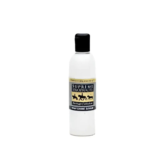 A clear plastic bottle with a black cap of supreme products heritage high shine serum featuring gold lettering and horses