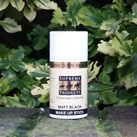 A matte black supreme products matt make up stick in a white container with horse silhouettes for horse owners