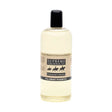 A clear plastic bottle with black cap holds pale yellow palomino shampoo from supreme products for palomino coats