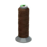 A spool of brown strong plaiting thread made of polyester on a gray base from supreme products plaiting thread standard