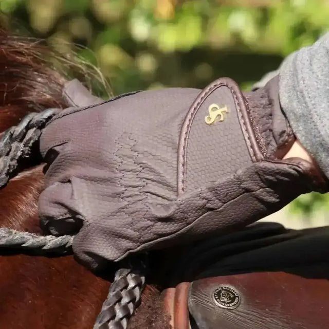 Dark brown leather ring riding gloves with gold logo on back from supreme products pro slimline performance gloves