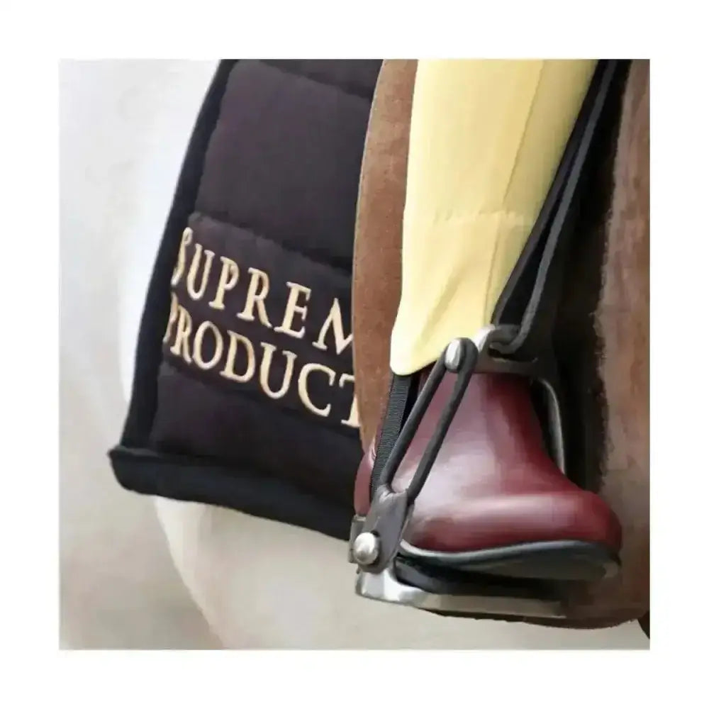 Black supreme branded saddle pad with gold embroidery shown with ring jodhpur boots for short riding use