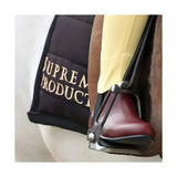 Black supreme branded saddle pad with gold embroidery shown with ring jodhpur boots for short riding use