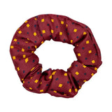 A maroon fabric hair scrunchie with yellow and dark blue squares as the final touch for ring attire