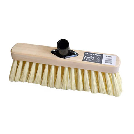 Sweeping broom with soft cream pvc bristles and black handle attachment on a light wooden floor